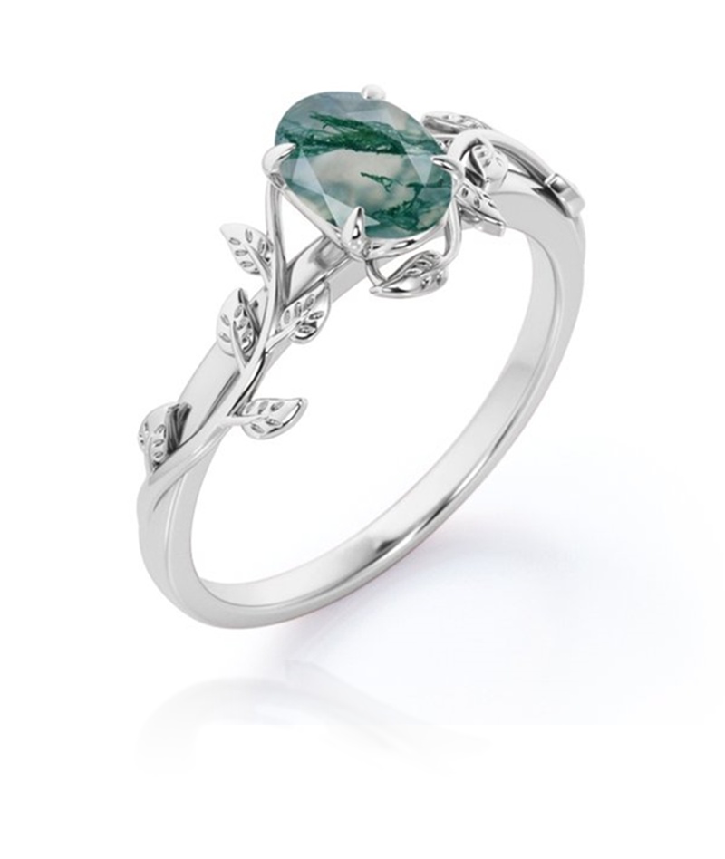 Angled view of moss agate engagement ring showing rose-cut oval stone and sterling silver leaf setting